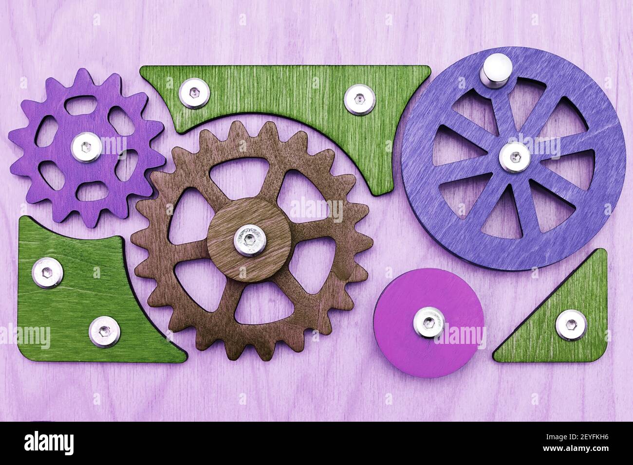 Eco friendly kids wooden busy board with gears and wheels. Kids toys and backgrounds Stock Photo