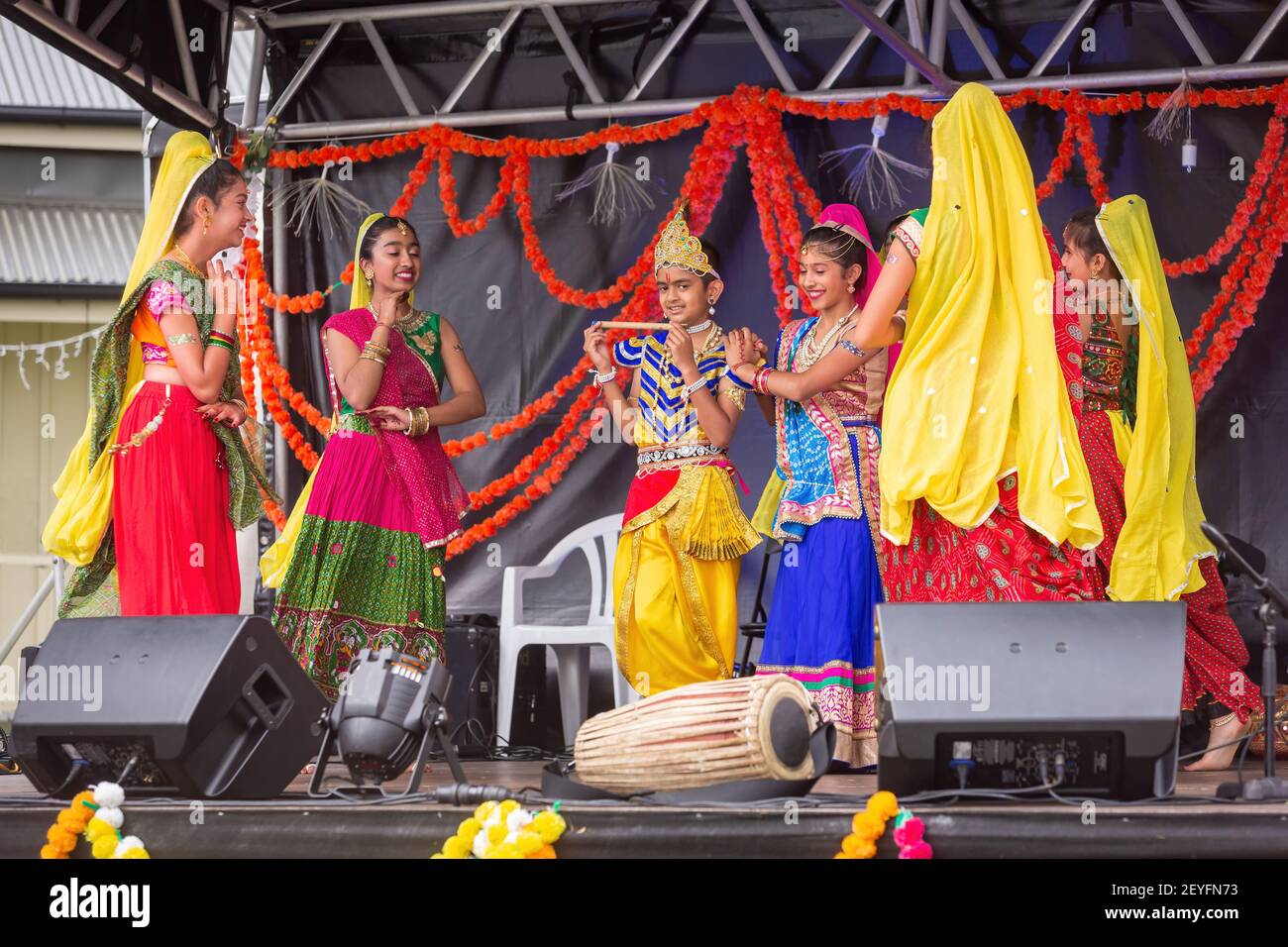 Young Indian girls in colorful traditional clothing performing on stage during celebrations of Diwali, the Hindu festival of light Stock Photo