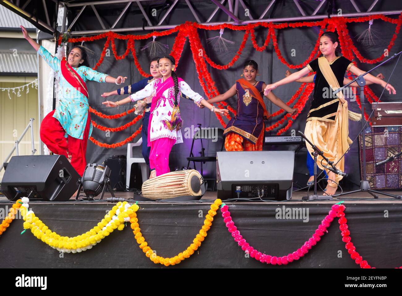 Young Indian girls dancing on stage to celebrate Diwali, the Hindu festival of lights Stock Photo