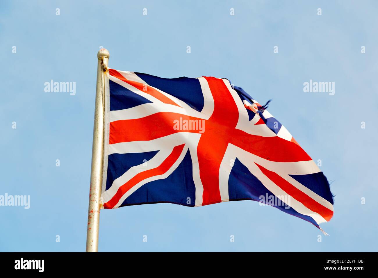 Waving flag in the blue sky Stock Photo