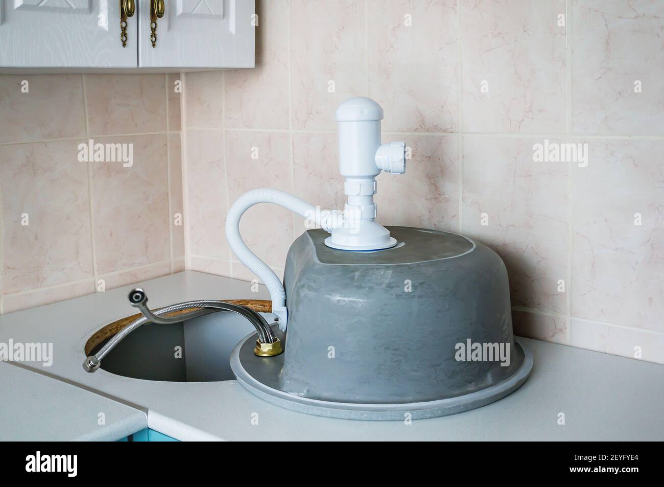 process of installing a stone sink in the countertop in the kitchen