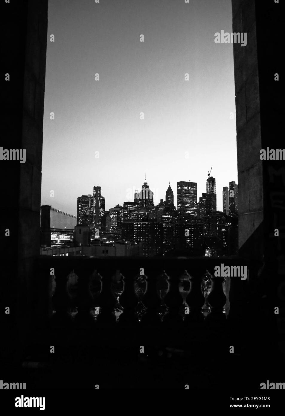 A vertical grayscale shot of the NYC skyline at night Stock Photo - Alamy