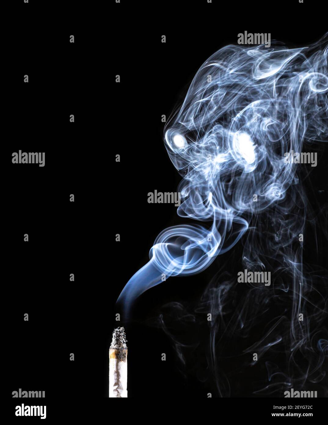 Portrait of a creepy demon made of smoke coming from a cigarette against a black background. Creative smoke art composition. The concept of fighting t Stock Photo