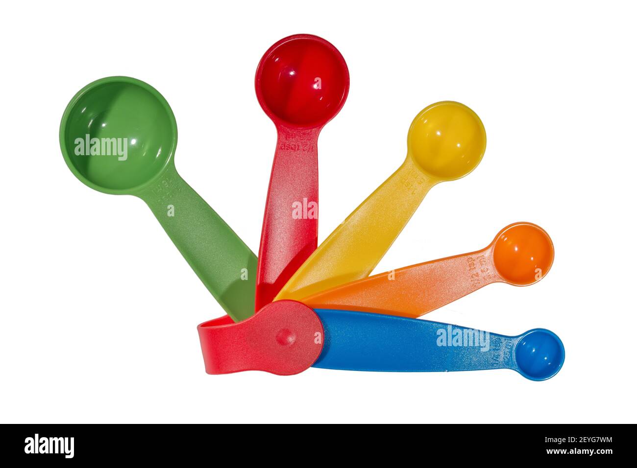 A colorful set of plastic measuring spoons in sizes from 1 tablespoon to 1/4 of a teaspoon Stock Photo