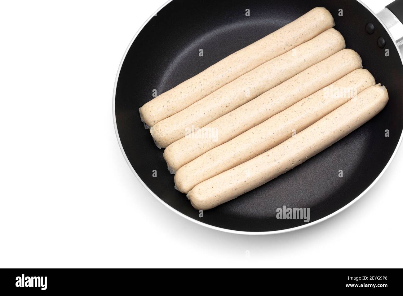 Crop view of five traditional german pork sausages on a frying pan