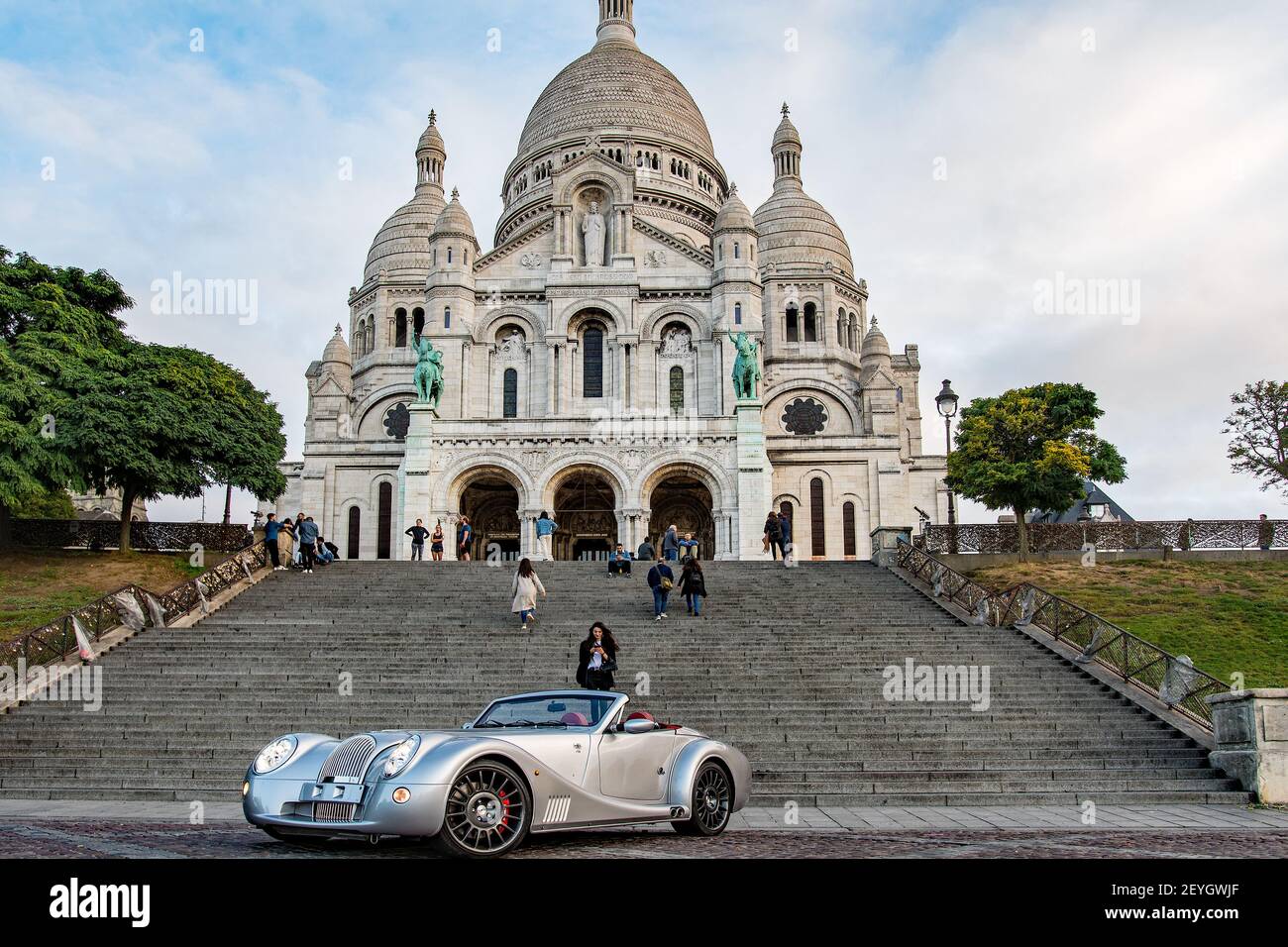 A fancy car parked in front of Sacré-Coeur cathedral Stock Photo