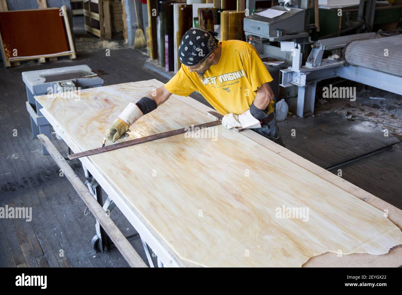 A worker cuts down sheets of stained glass at the The Paul Wissmach