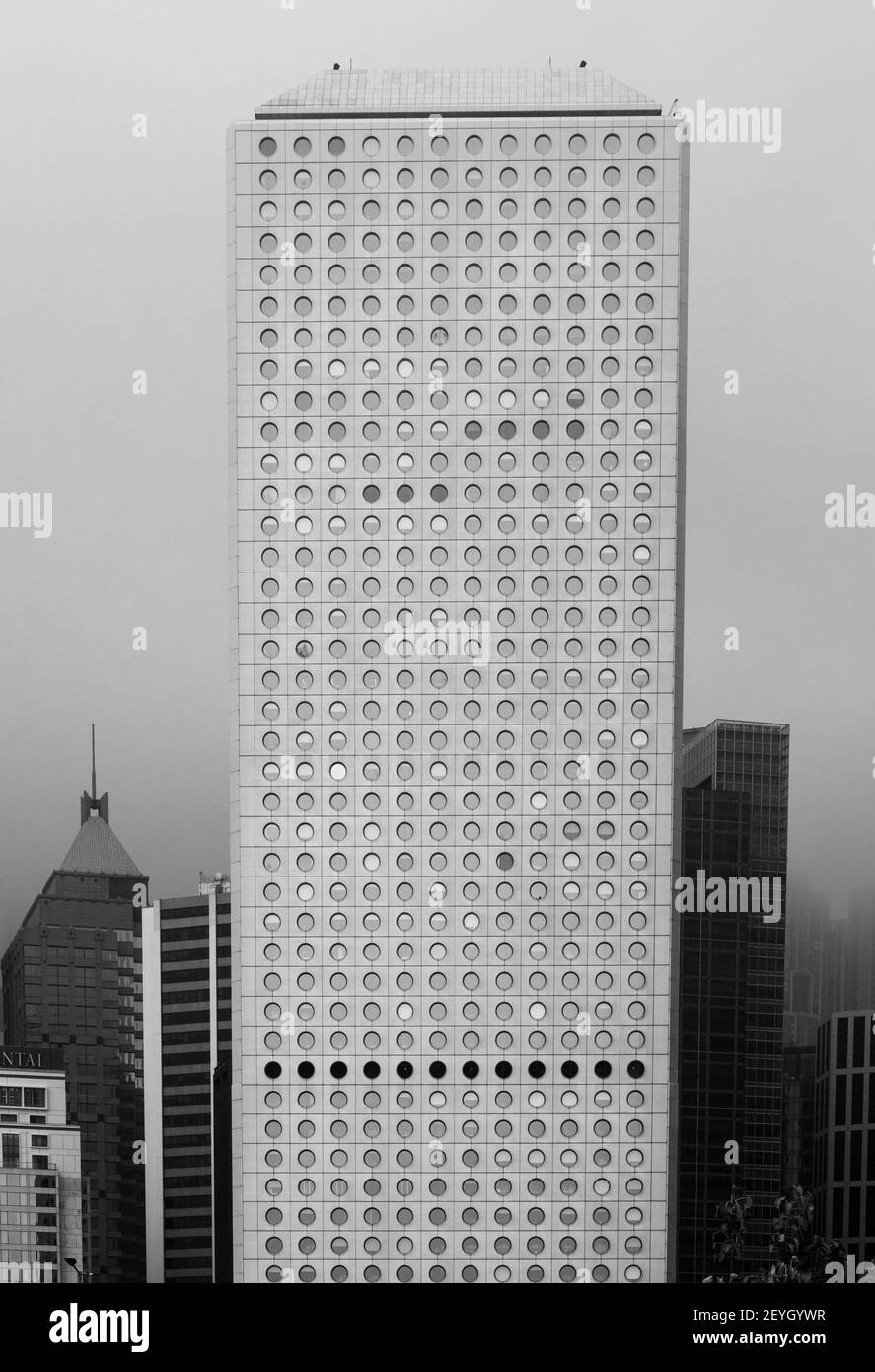 Jardine House, Central, Hong Kong on a cloudy day. This famous building