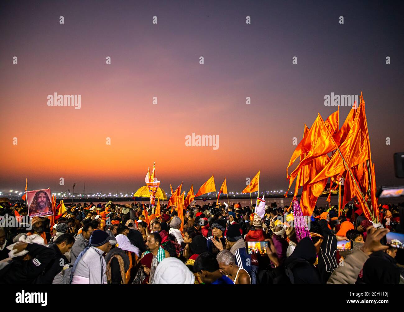 saffron flags at kumbh mela during the royal bath at ganges ghat. Stock Photo