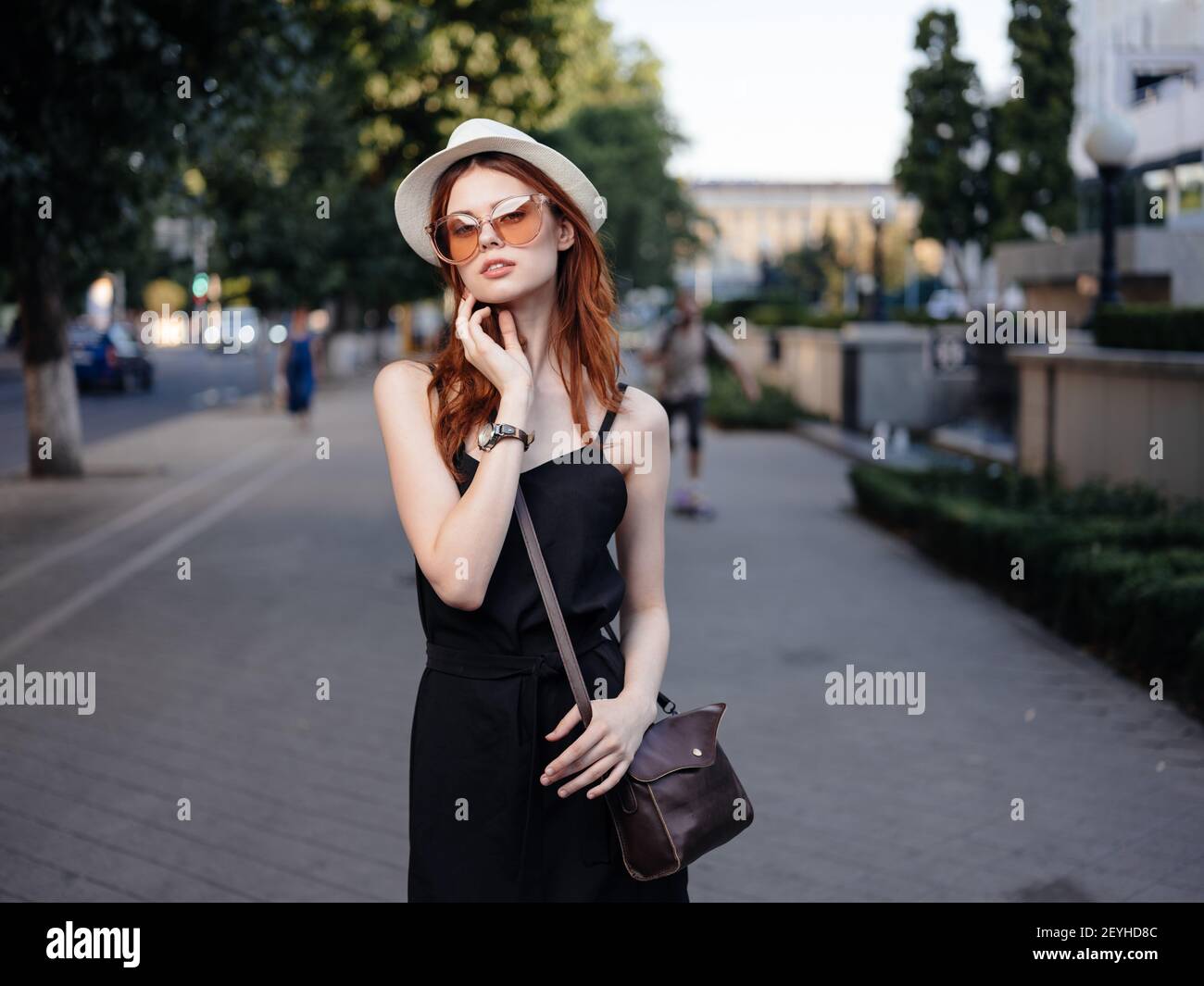 Beautiful woman in black dress walks back hi-res stock photography and ...