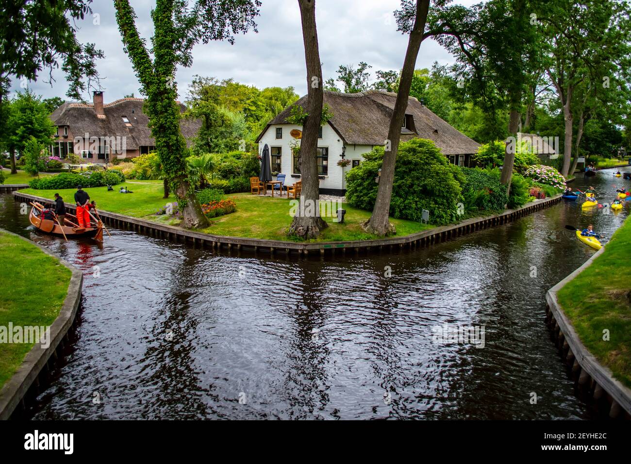 Giethoorn, Netherlands - July 6, 2019: People paddling boats on the canals of Giethoorn village, known as the Venice of the Netherlands Stock Photo