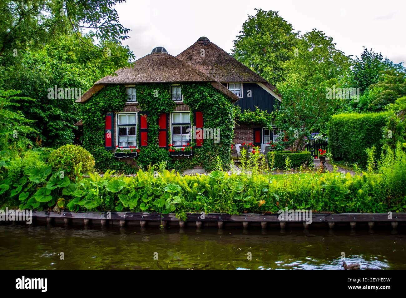 Giethoorn, Netherlands July 6, 2019 Beautiful Dutch village house with traditional roof and
