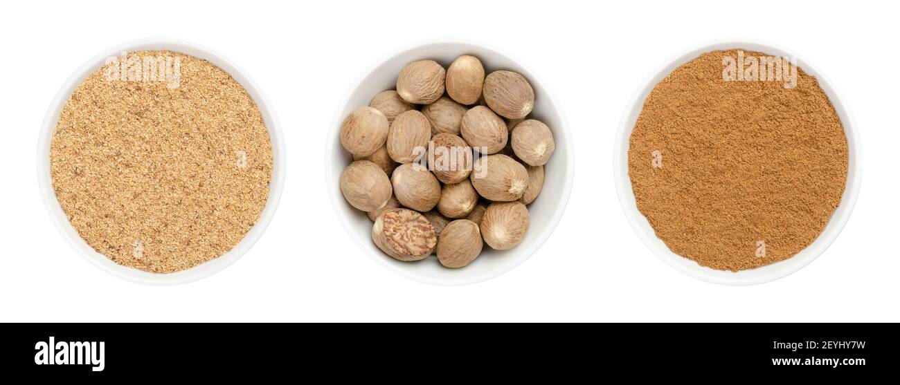 Whole nutmegs, freshly grated and powdered nutmeg in white bowls. Fragrant or true nutmeg, dried seeds of Myristica fragrans, used as spice. Stock Photo