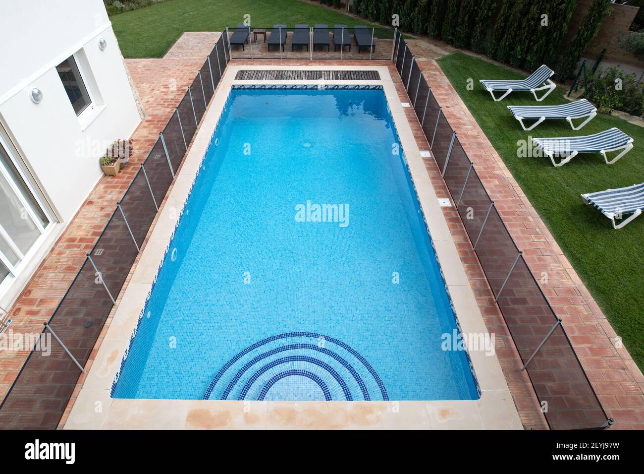 High angle view of a swimming pool with child safety fence around it Stock Photo