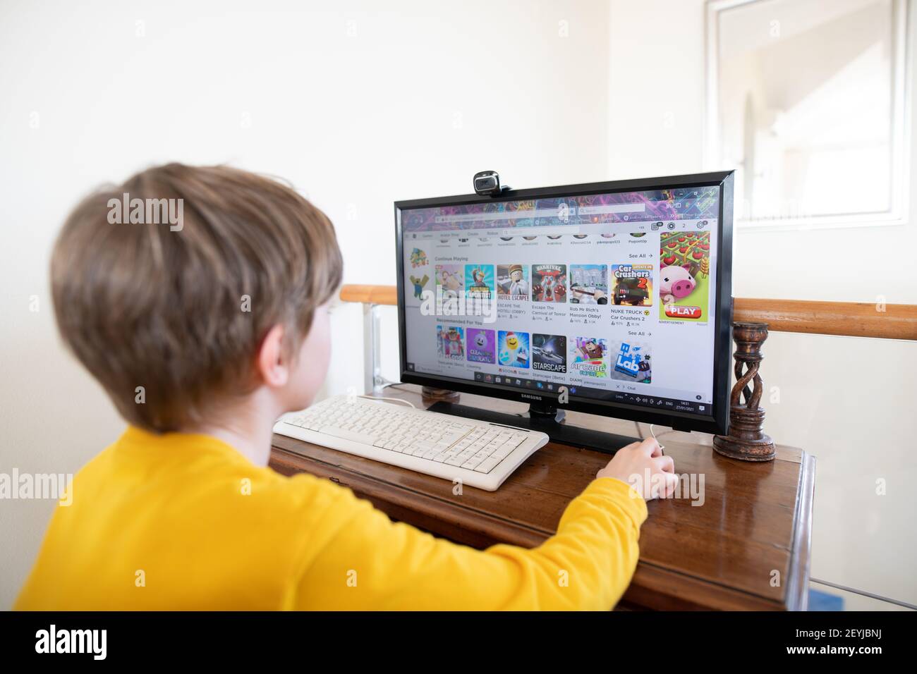 Lagos, Portugal: February 2021; Young boy playing the online game platform, Roblox on a PC at home Stock Photo