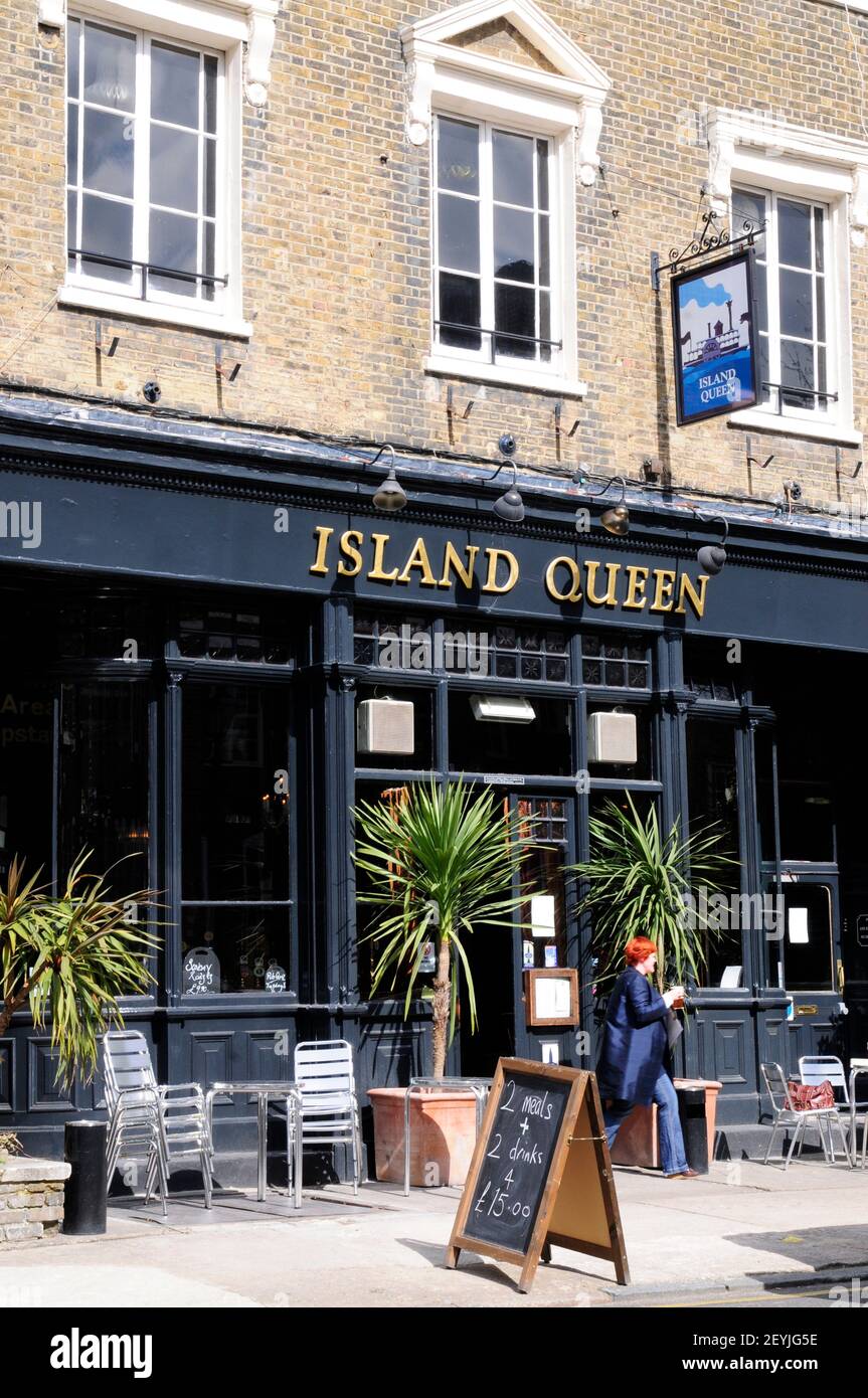 A lady coming out of the Island Queen pub, Islington, London, England Stock Photo