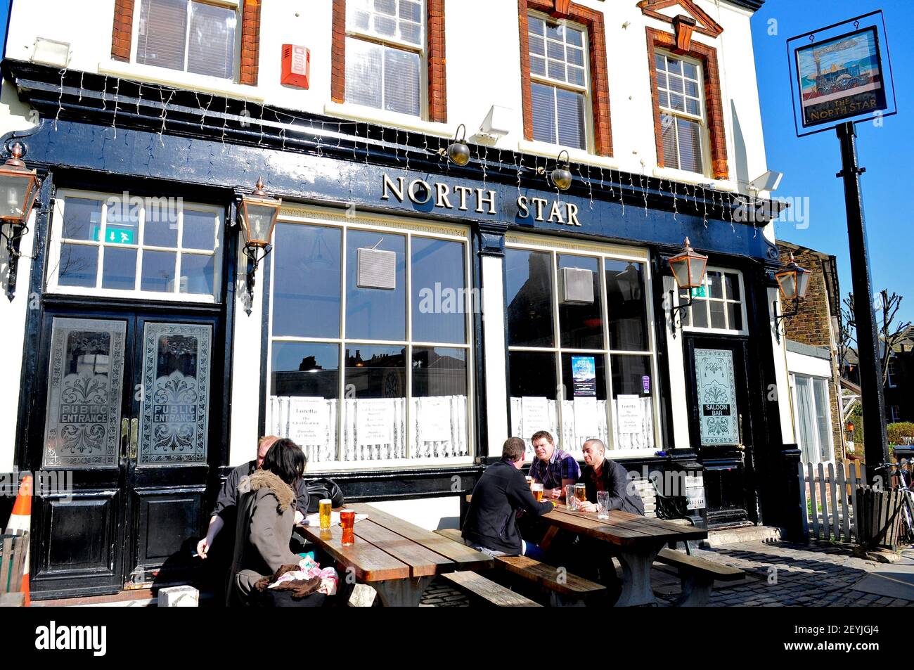 People chatting outside The North Star pub in Leytonstone, London, England Stock Photo