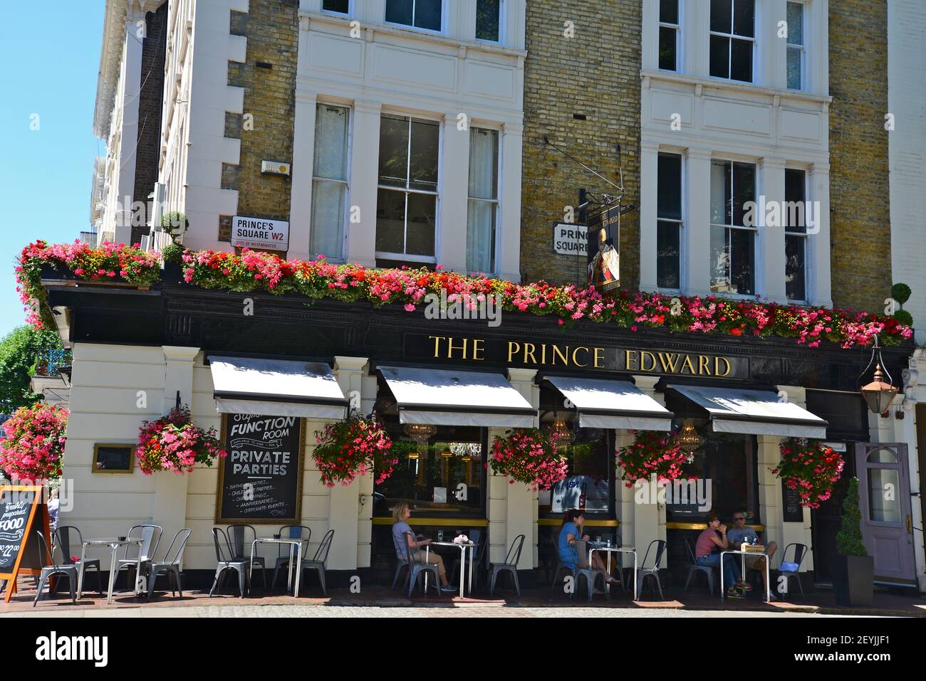 People chatting outside The Prince Edward pub in Bayswater, London, England Stock Photo