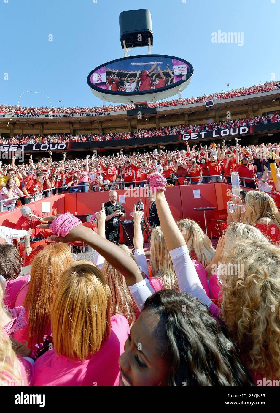 Fans and Kansas City Chiefs cheerleaders cheer as they surround the