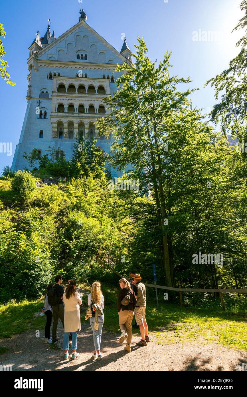 Group of tourists in front of the 19th century romantic eclecticism palace Neuschwanstein Castle in Schwangau, Bavaria, Germany, Europe Stock Photo