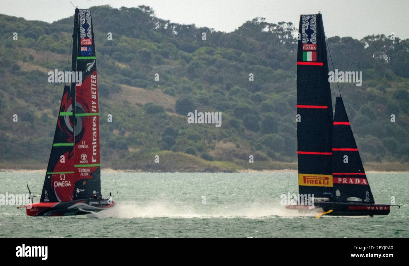 Auckland, New Zealand, 6 March, 2021 -  Italian team Luna Rossa Prada Pirelli, co-helmed by Jimmy Spithill and Francesco Bruni, and Emirates Team New Zealand's Te Rehutia, skippered by Peter Burling, pass each  as both teams practice separately on Auckland's Waitemata Harbour.  The two teams will contest the 36th America's Cup starting March 10. Credit: Rob Taggart/Alamy Live News Stock Photo