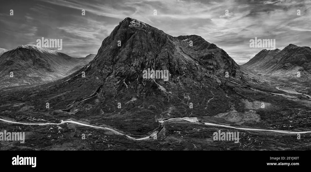 Flying drone dramatic  black and white landscape image of Buachaille Etive Mor and surrounding mountains and valleys in Scottish Highlands on a Winter Stock Photo