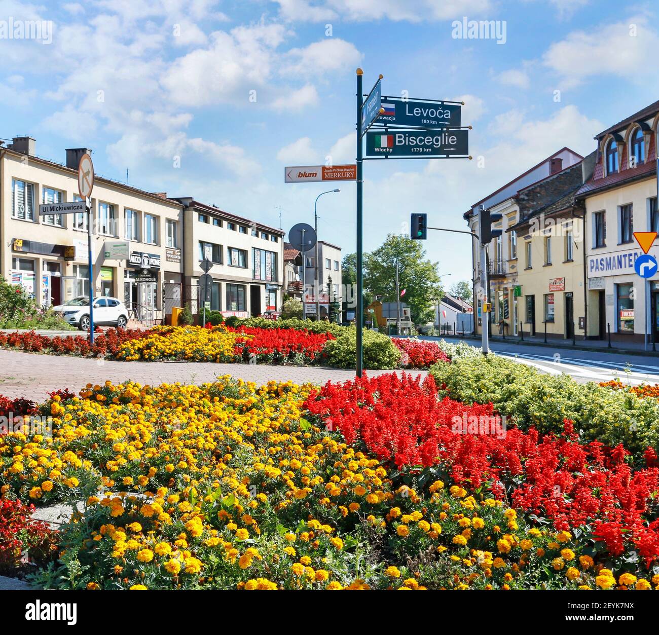 The central point of Kalwaria Zebrzydowska city with beautiful flower bed and with the signpost with distances to European cities. Stock Photo