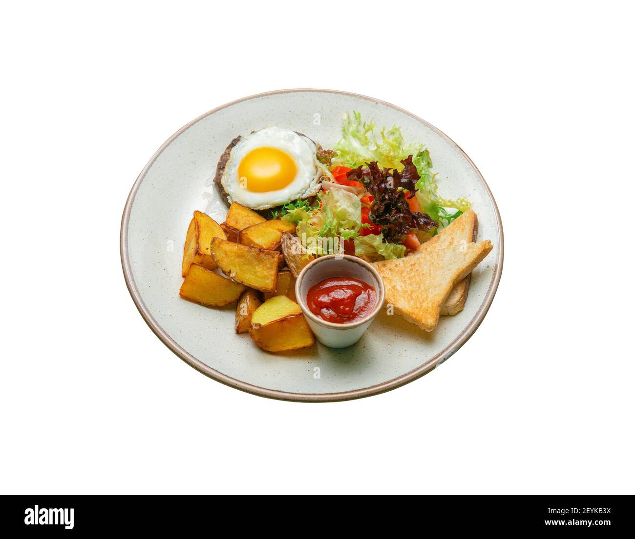 Fried potatoes with scrambled eggs and cutlet. Toast, vegetable salad and ketchup. Hearty breakfast. Stock Photo