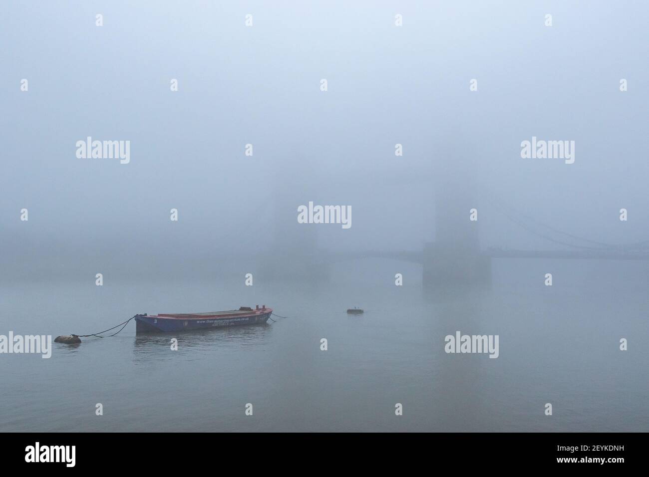 Iconic Tower Bridge and the River Thames shrouded in mist, creating a gothic vision, reminiscent of the London of yesteryear. With copy space - Stock Image