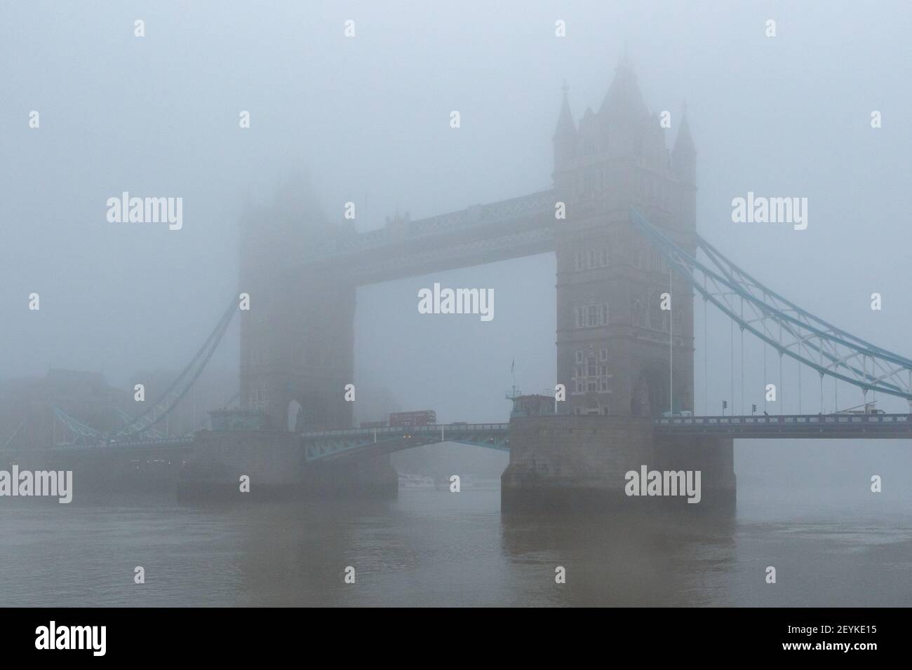 The iconic Tower Bridge and the River Thames shrouded in mist, creating a wonderfully gothic vision, reminiscent of the London of yesteryear. - Stock Image