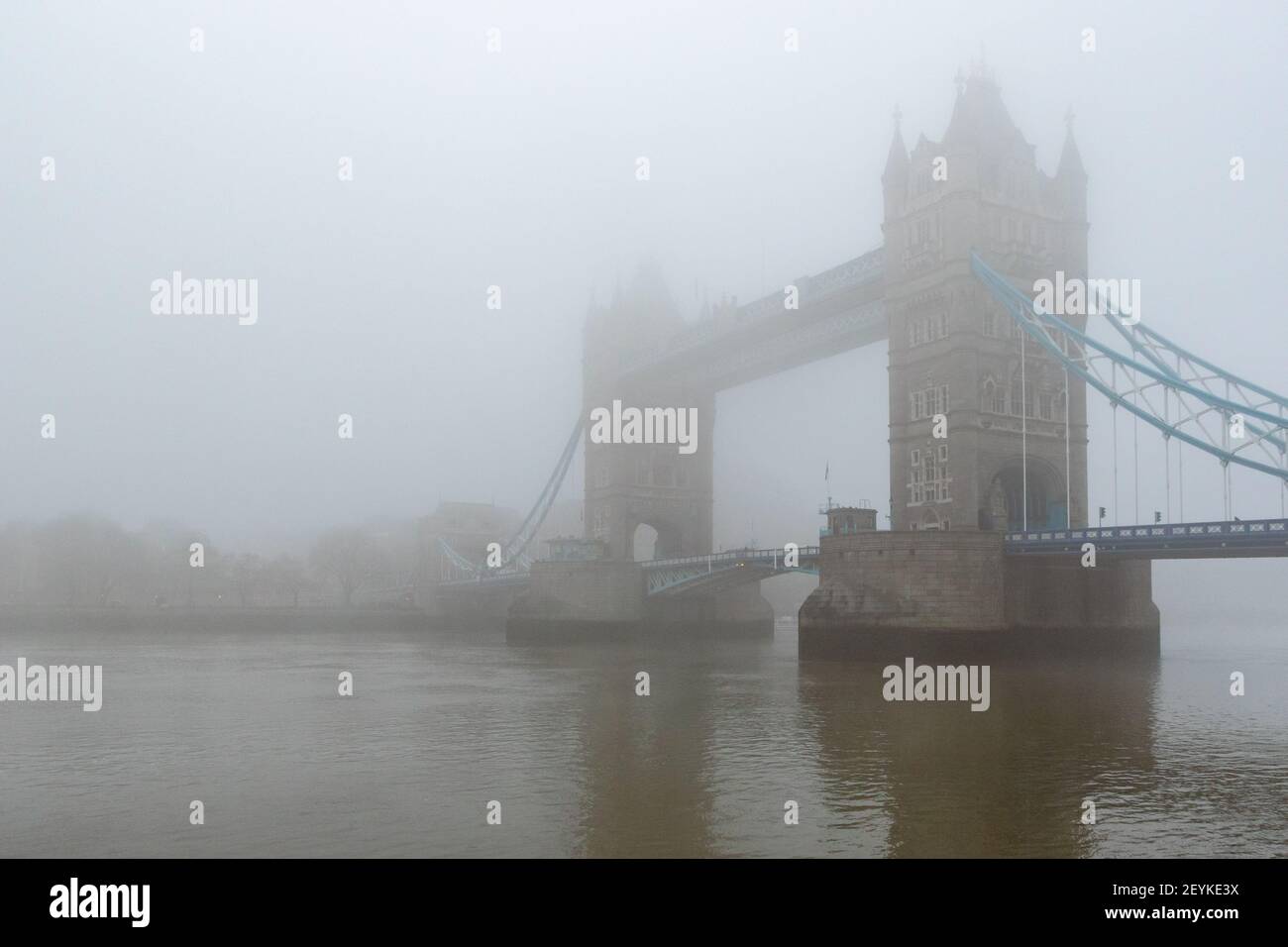 Iconic Tower Bridge and the River Thames shrouded in mist, creating a gothic vision, reminiscent of the London of yesteryear. With copy space - Stock Image