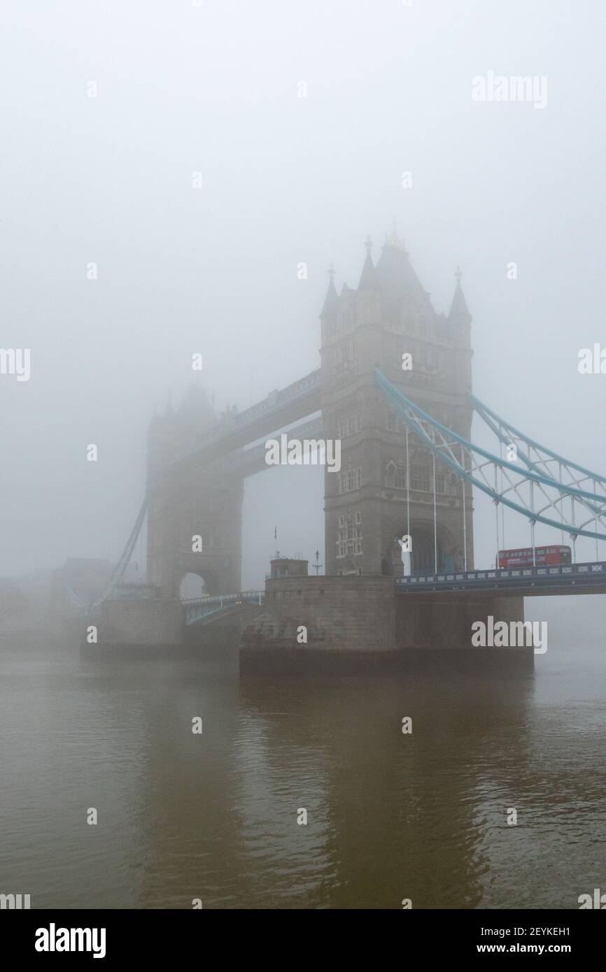 Iconic Tower Bridge and the River Thames shrouded in mist, creating a gothic vision, reminiscent of the London of yesteryear. With copy space - Stock Image