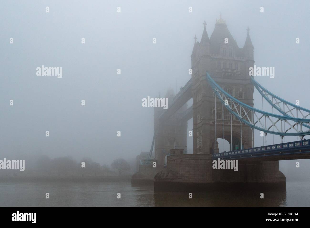 Iconic Tower Bridge and the River Thames shrouded in mist, creating a gothic vision, reminiscent of the London of yesteryear. With copy space - Stock Image