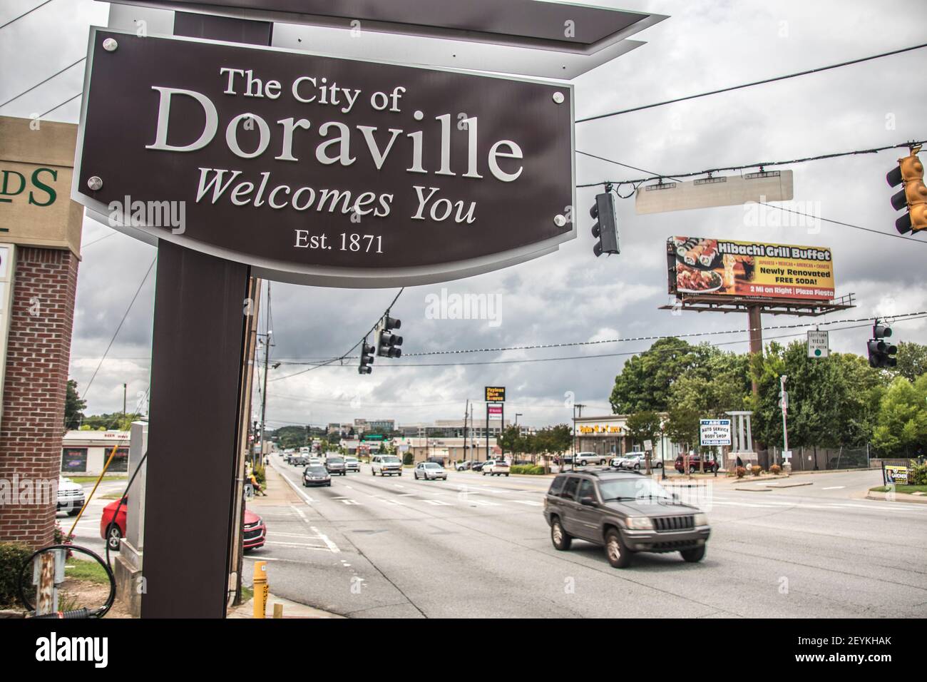 Doraville, Ga / USA - 07 06 20: View of a Welcome to Doraville sign with traffic and cloudy skies Stock Photo