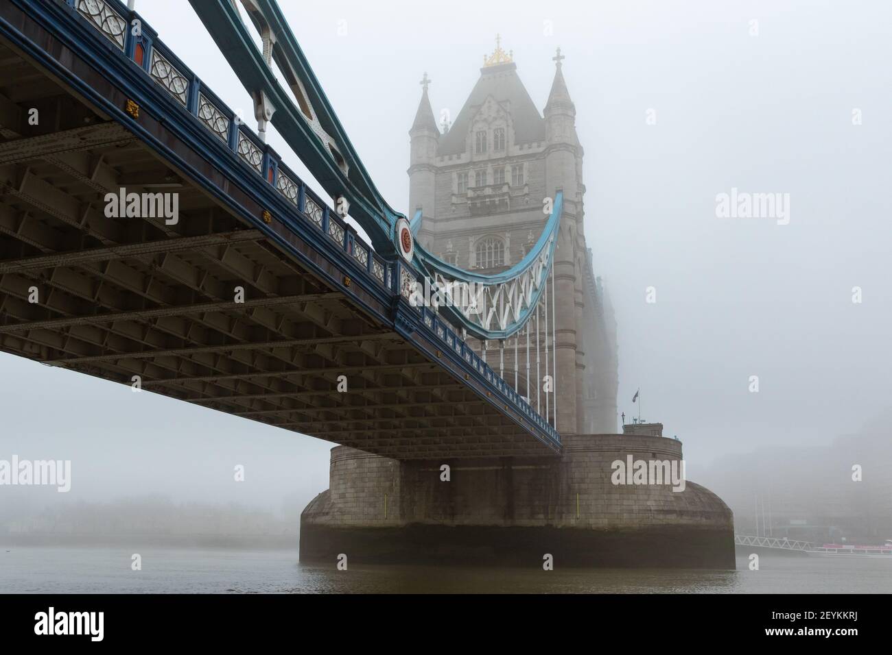 Iconic Tower Bridge and the River Thames shrouded in mist, creating a gothic vision, reminiscent of the London of yesteryear. With copy space - Stock Image