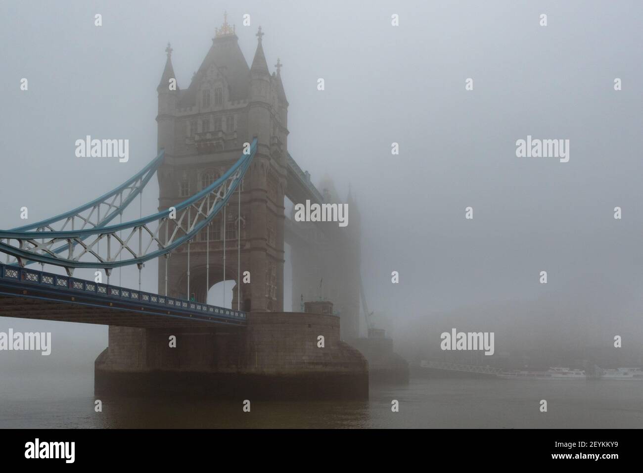 Iconic Tower Bridge and the River Thames shrouded in mist, creating a gothic vision, reminiscent of the London of yesteryear. With copy space - Stock Image