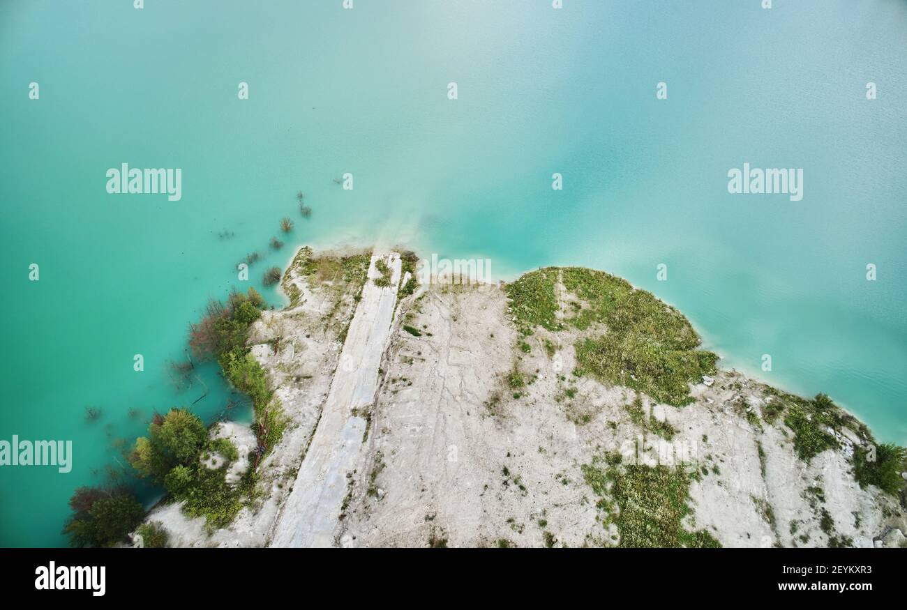 Quarry shore with green water above top view Stock Photo