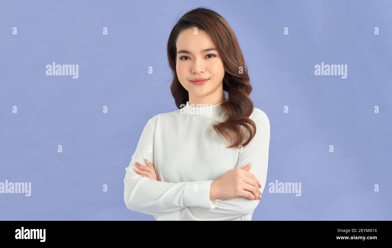 Young cute woman smiling confident with crossed arms Stock Photo - Alamy