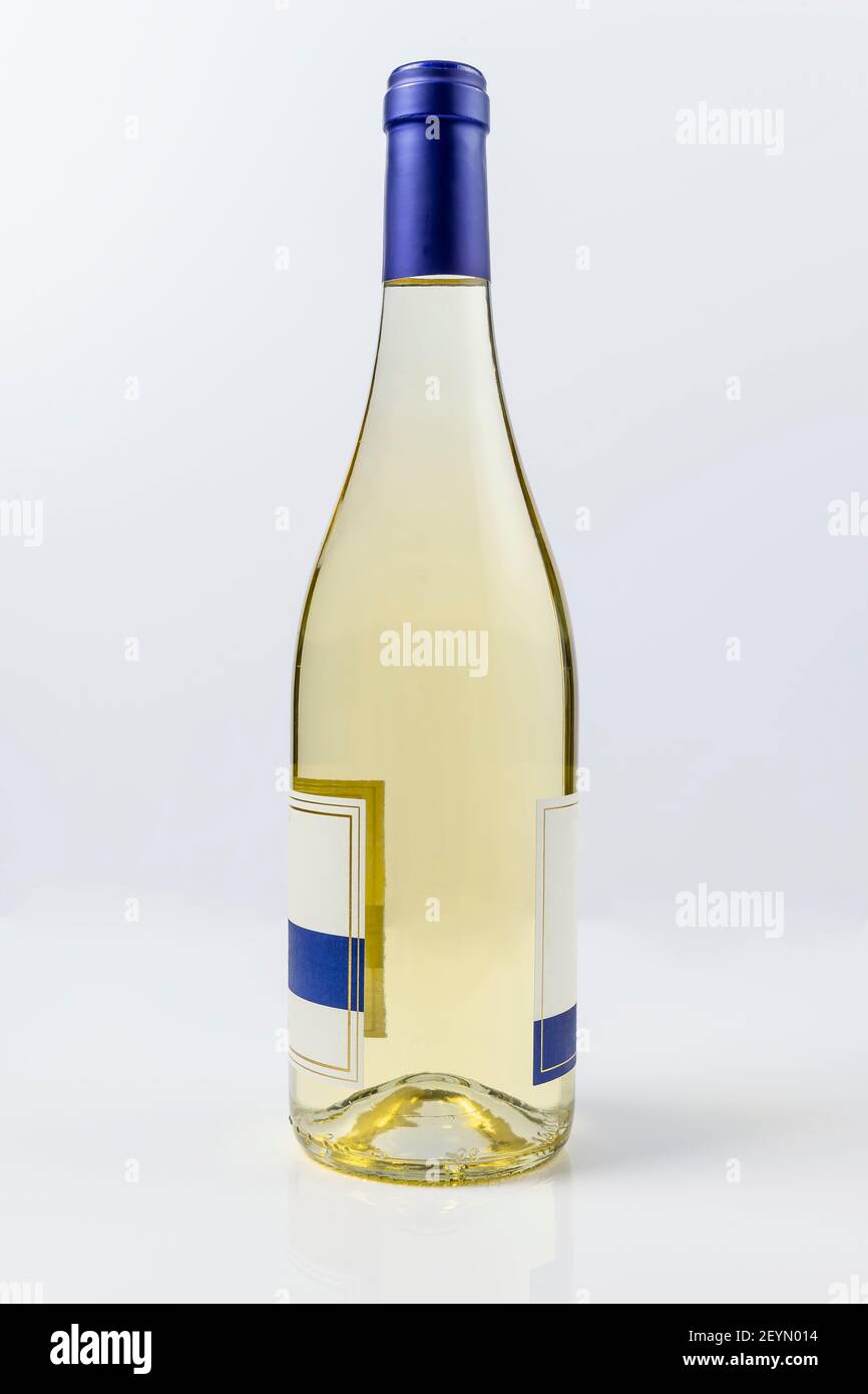Beautiful burgundy style bottle of white wine on white surface and background Stock Photo