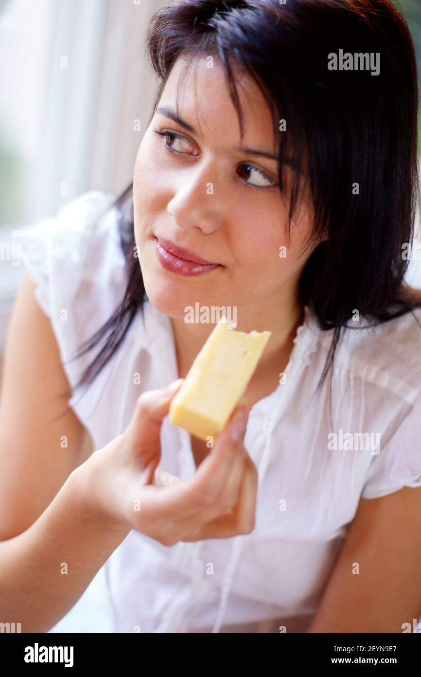 Woman eating cheese Stock Photo