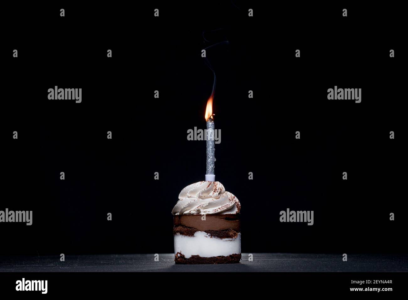 Birthday Cake with a candle on a black background Stock Photo - Alamy