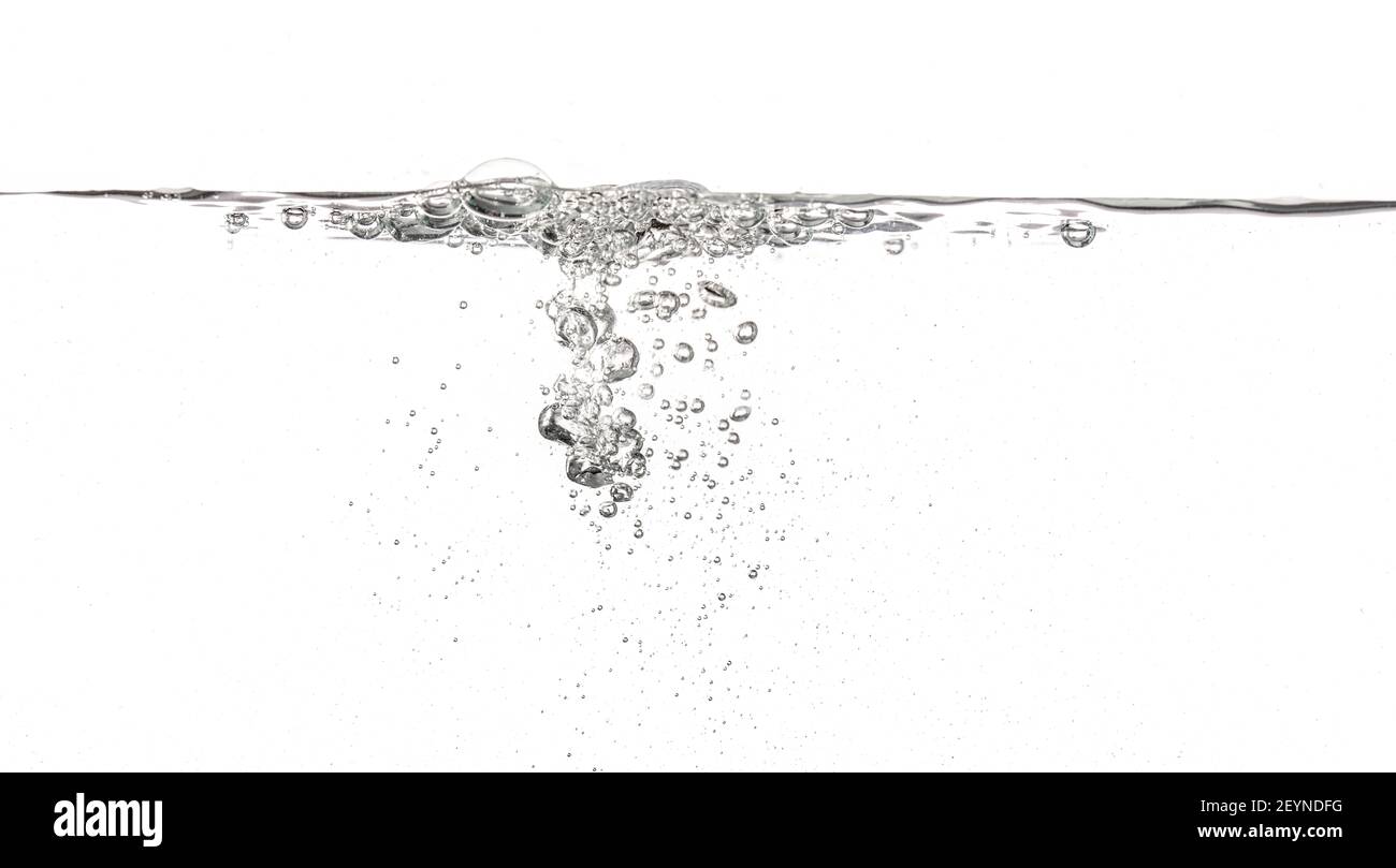 Water poured into tank, bubbles and splashes visible on white background Stock Photo