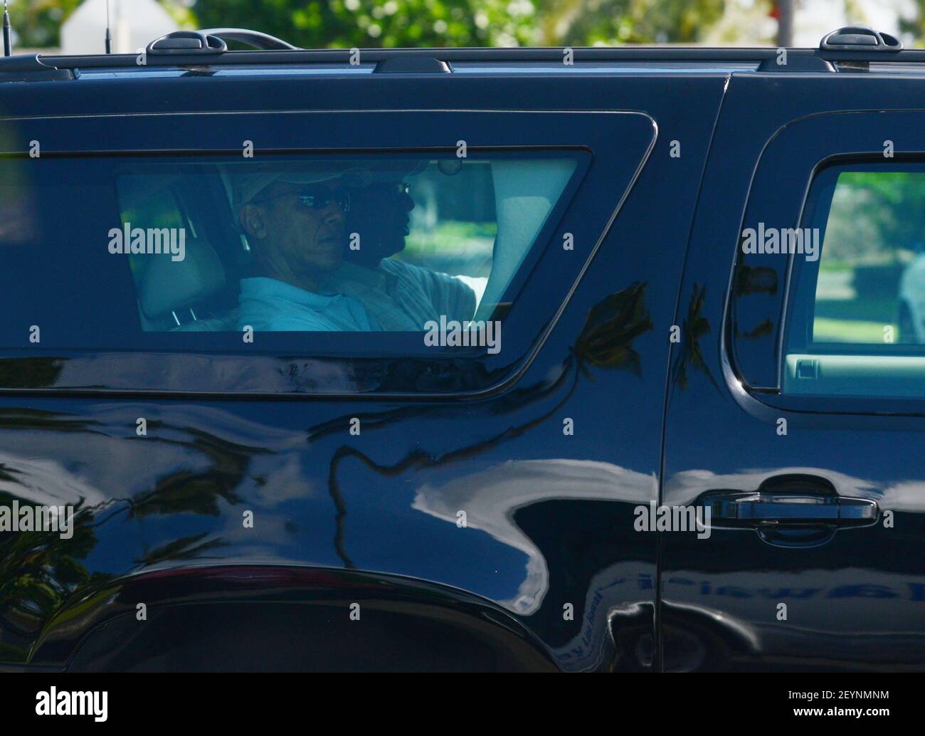 President Barack Obama rides in his armored SUV on his way out of ...