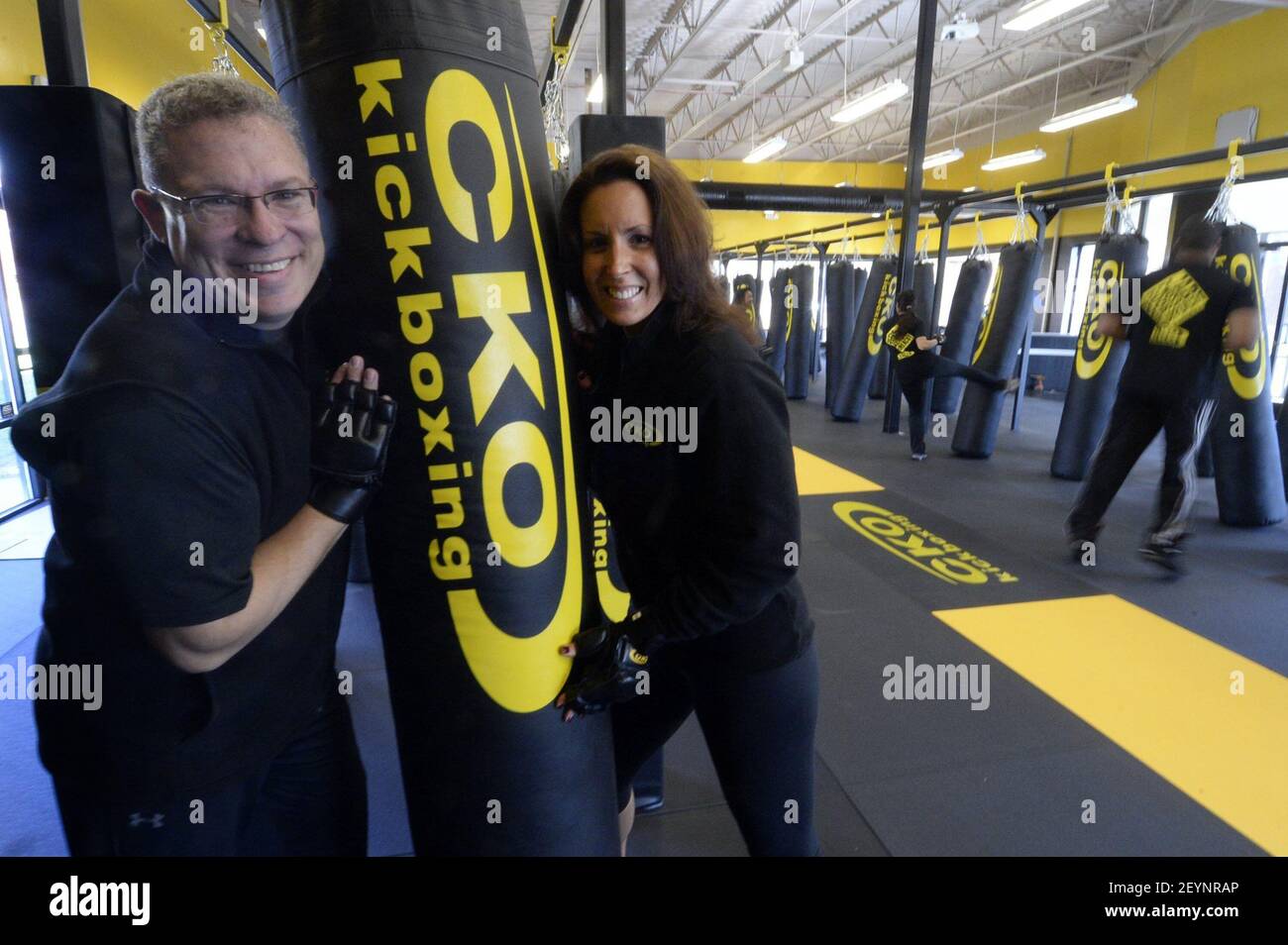 Amy and Danny Leon, coowners of CKO Kickboxing, pose for a photo in