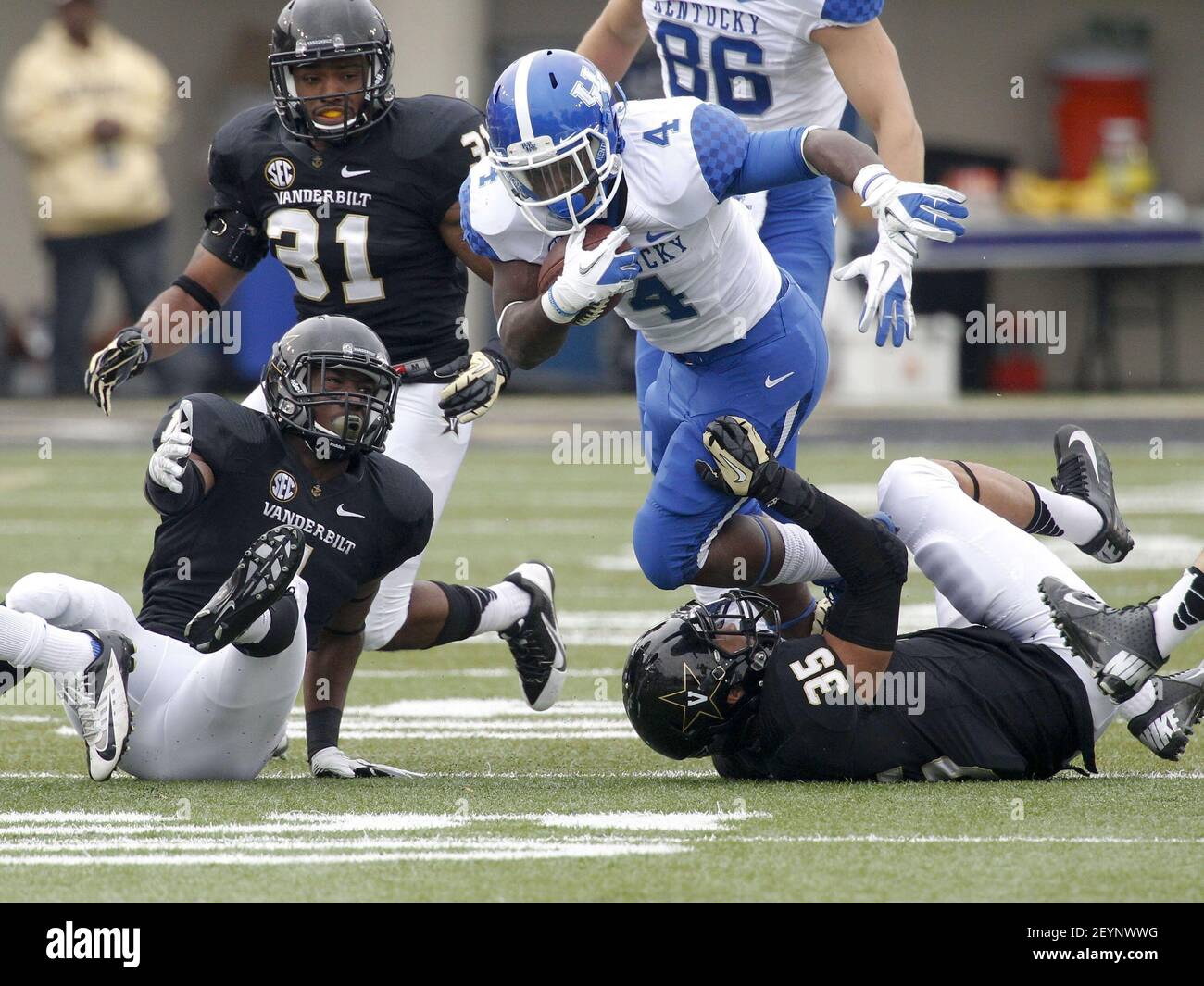 Raymond Sanders (4) of Kentucky runs over Darreon Herring (35) of