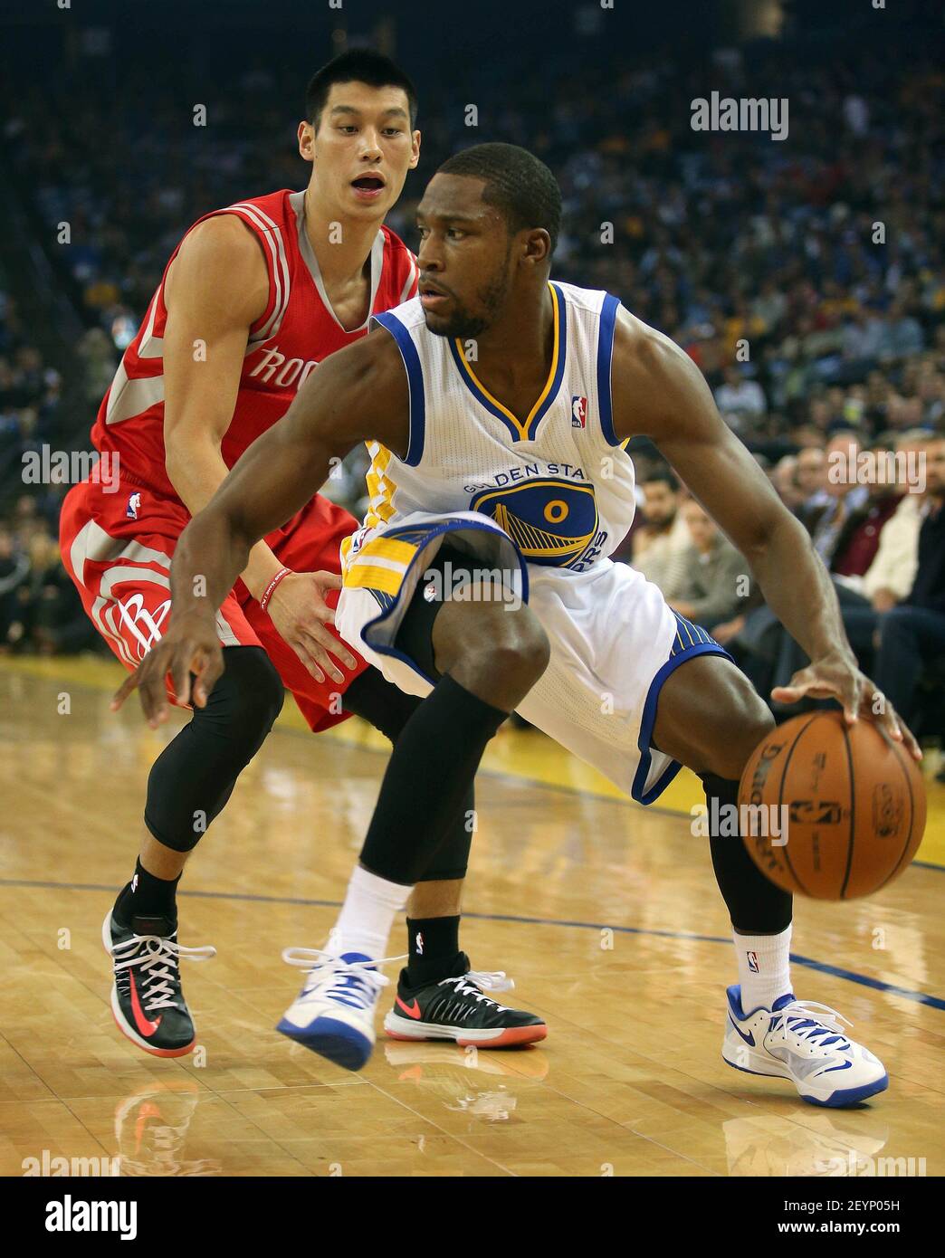 The Golden State Warriors Toney Douglas 0 works against the Houston Rockets Jeremy Lin left during the first quarter at Oracle Arena in Oakland Calif. on Friday Dec. 13 2013. Photo by