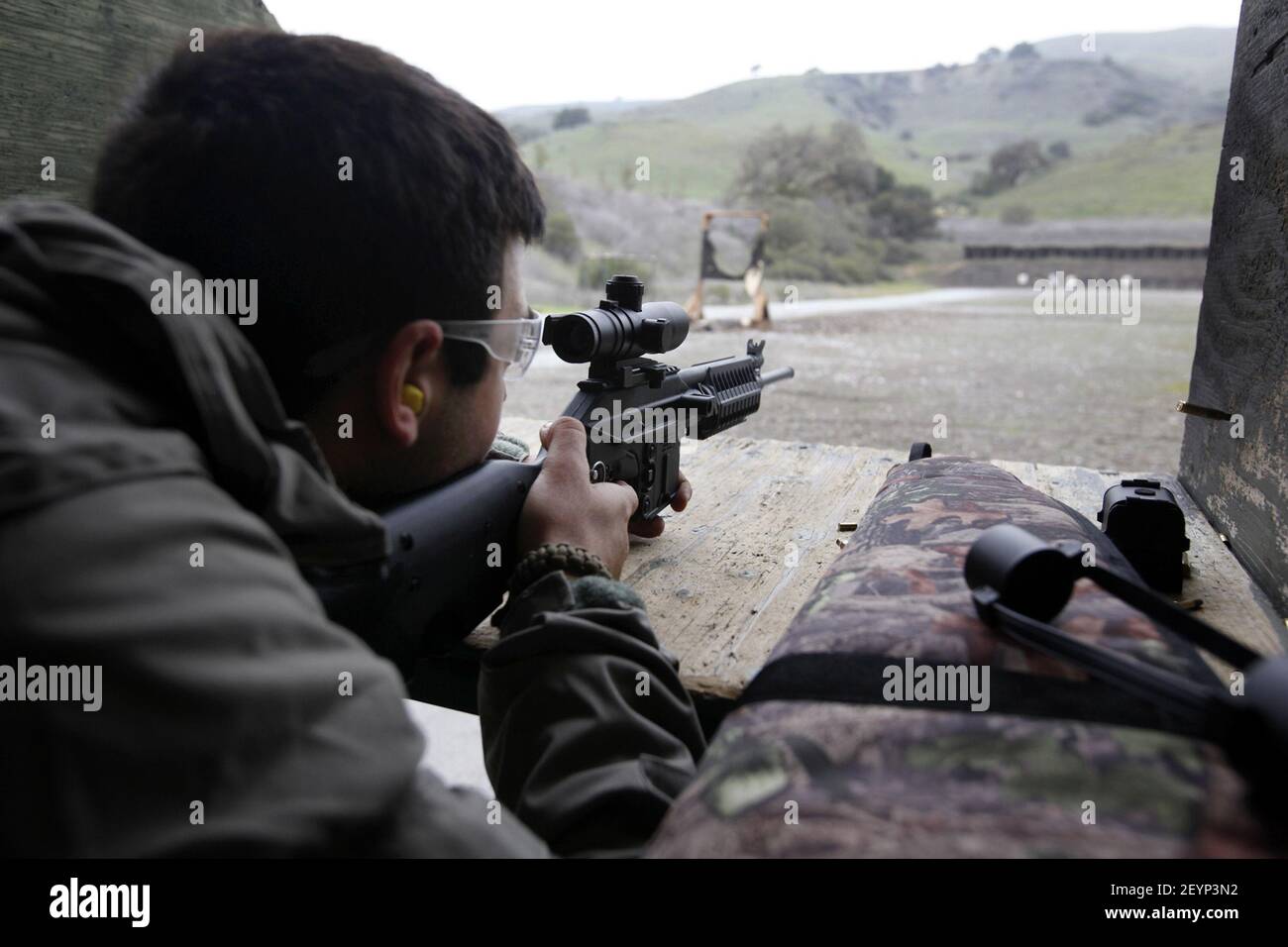 Bijan Moeinzadeh, a Naval medic, takes target practice at the county