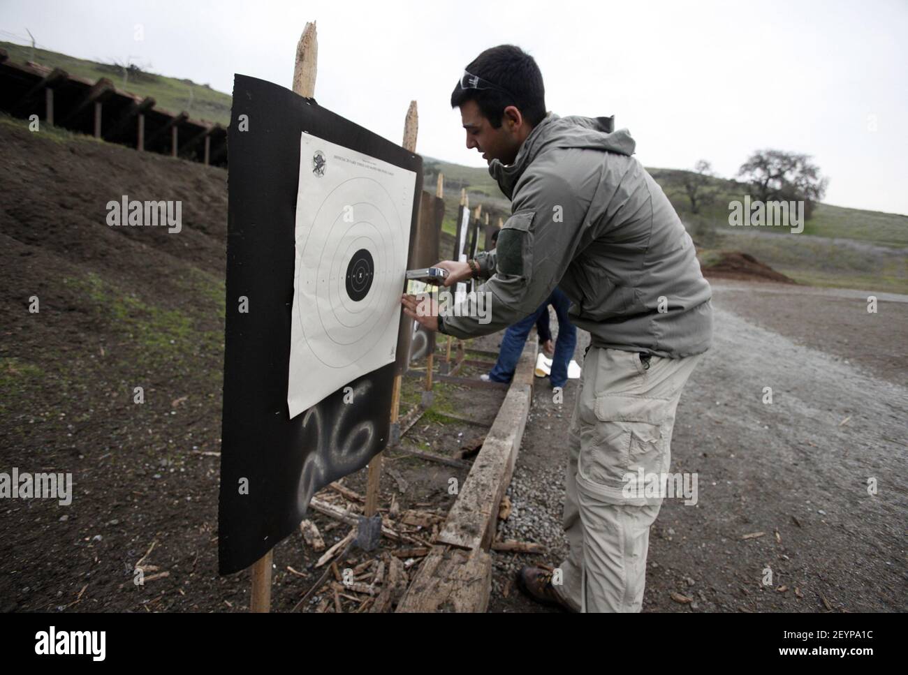 Bijan Moeinzadeh, a Naval medic, prepares for target practice at the