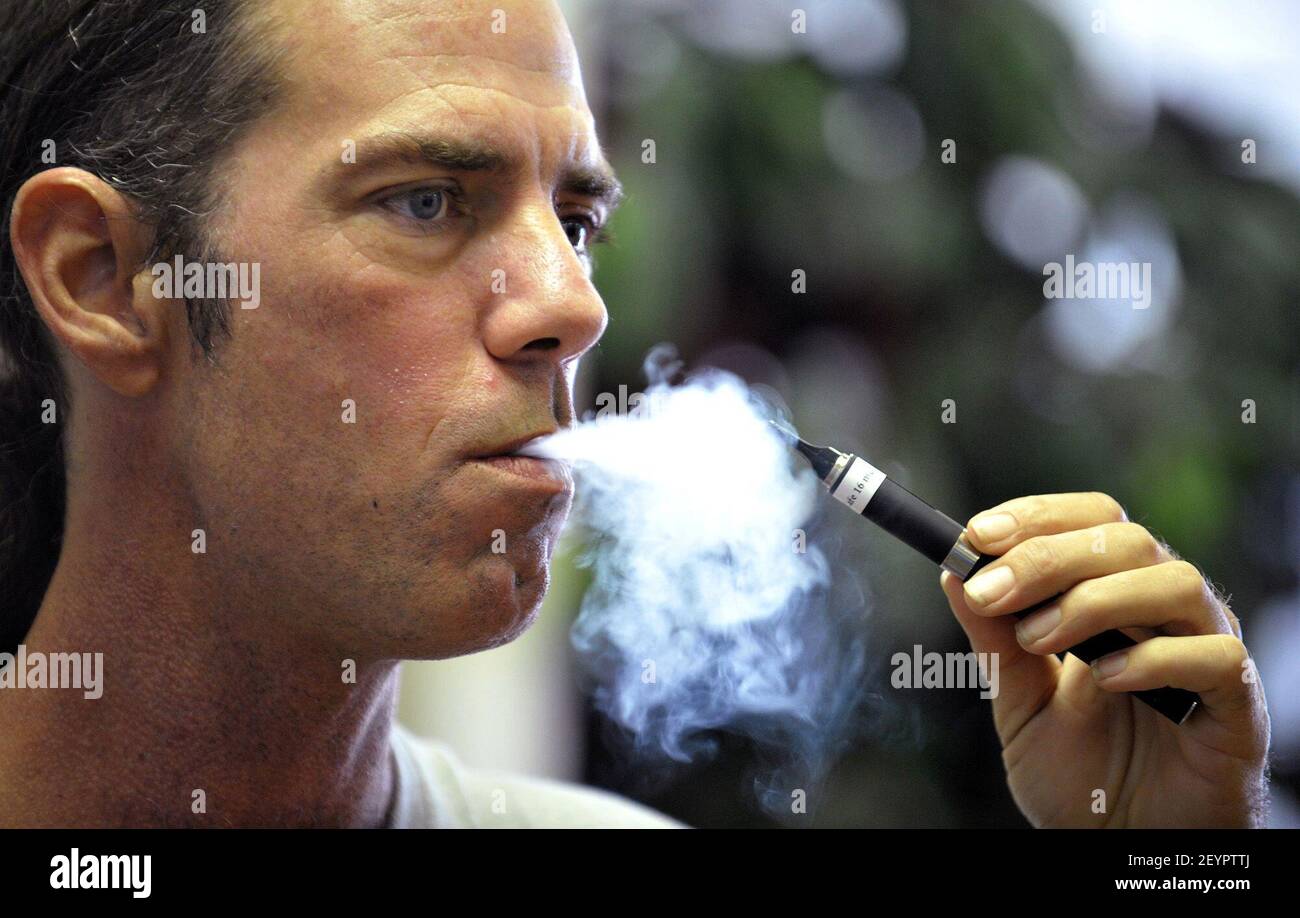 Tyler Bush, manager of The Vapor Bar in Grapevine, Texas, puffs on an  electronic cigarette. (Photo by Max Faulkner/Fort Worth Star-Telegram/TNS/Sipa  USA Stock Photo