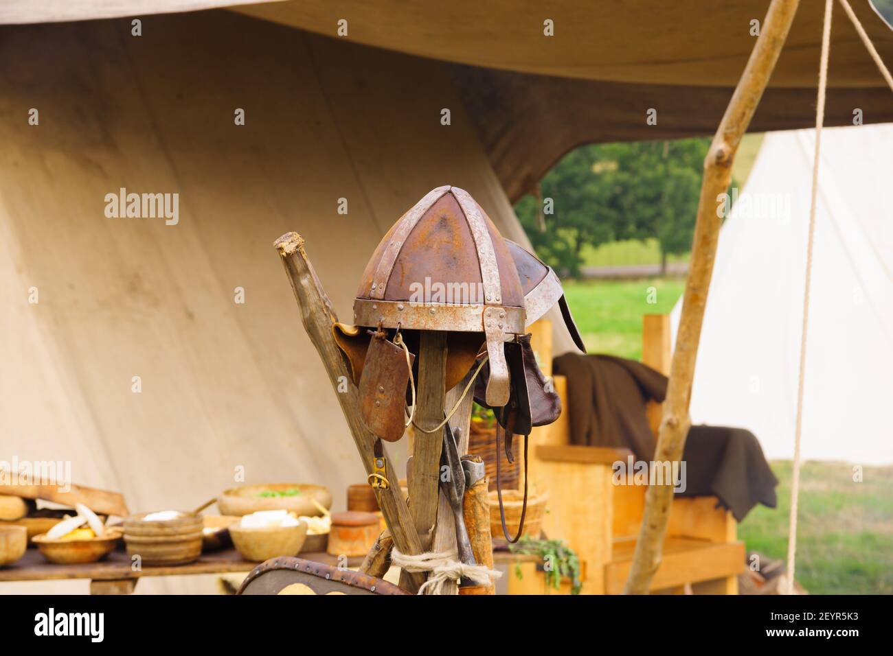 Early medieval spangenhelm or leather skull cap with metal reinforcements in a re-enactment camp Stock Photo